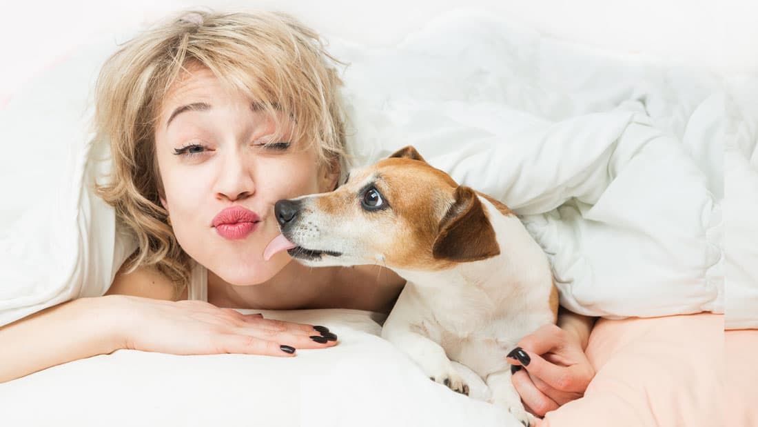 A woman playing with her dog and missing work