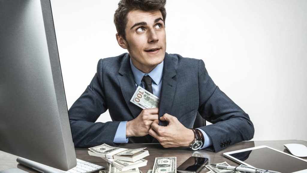 A man in a suit steeling money