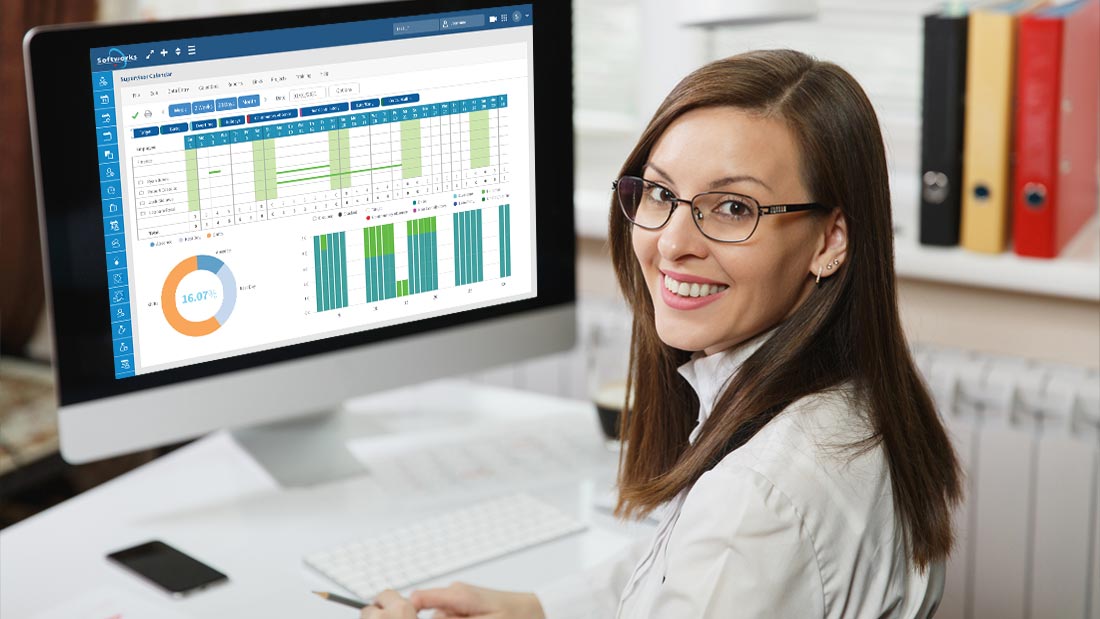 A lady working on workforce reports using Softworks software.